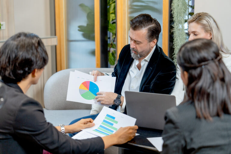 Professionals reviewing financial charts during a corporate valuation process for litigation support.
