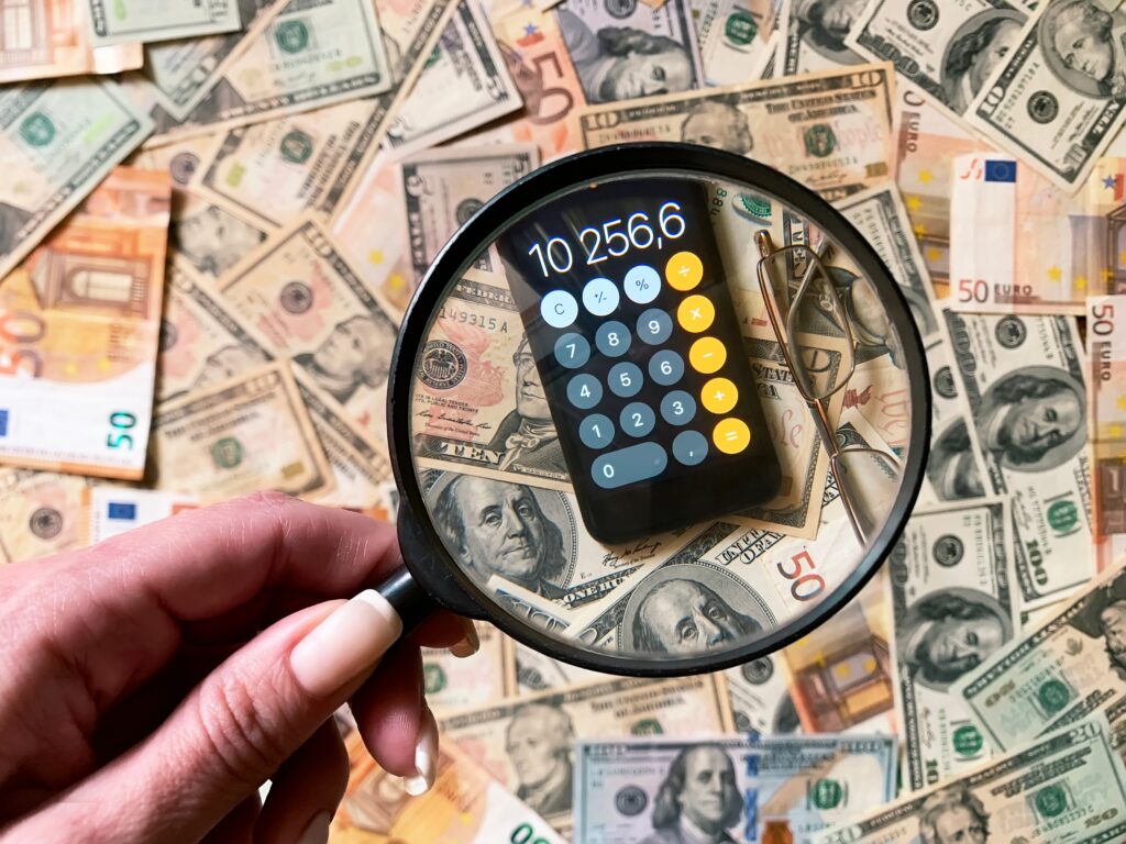 A forensic accountant using investigative tools to examine financial evidence and uncover fraud.