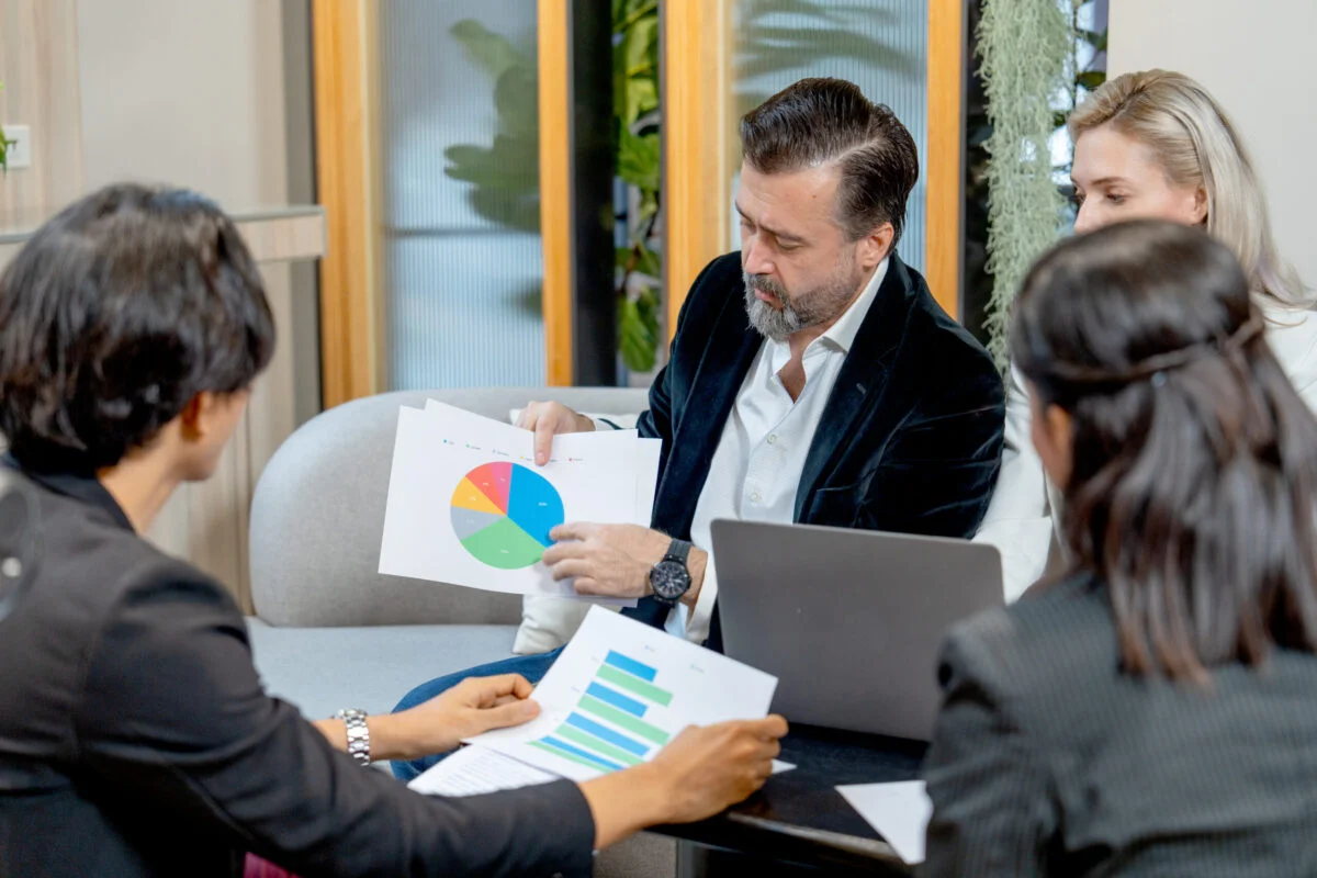Professionals reviewing financial charts during a corporate valuation process for litigation support.